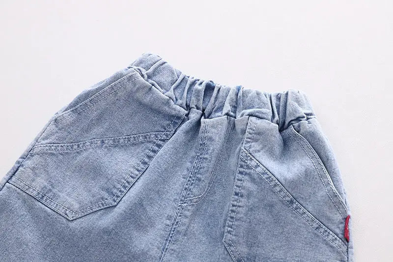 Fun boys' outfit with 3D shark tail T-shirt and denim shorts from Ju Ju Jam