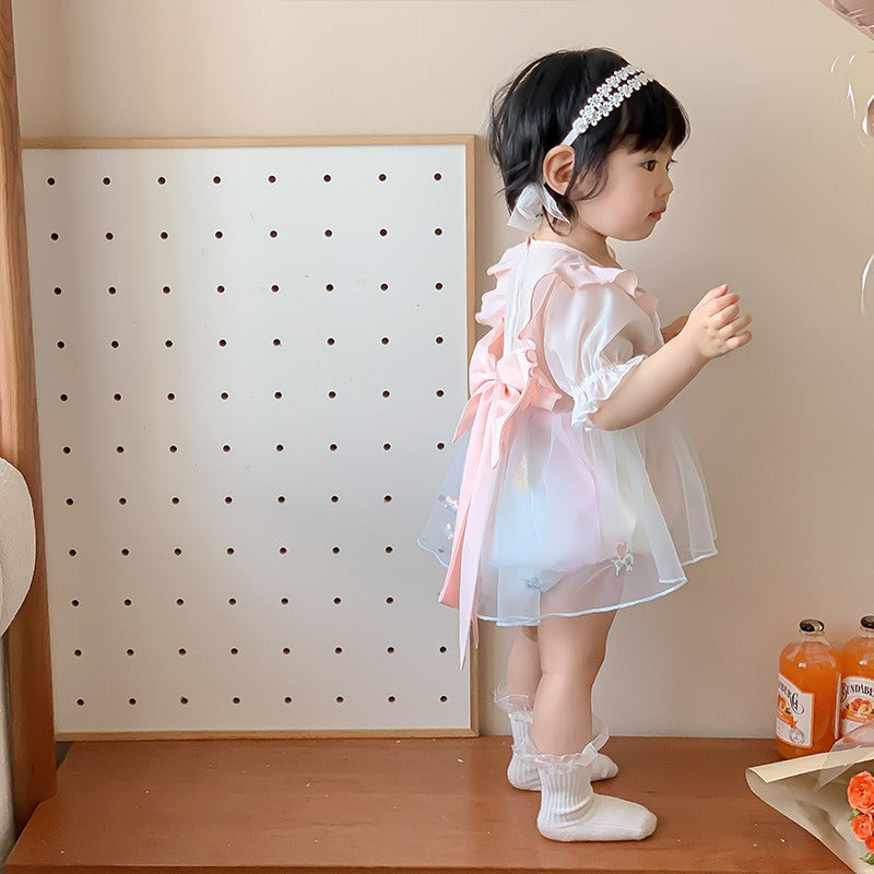Smiling baby girl wearing Princess Romper β perfect for birthdays or special events