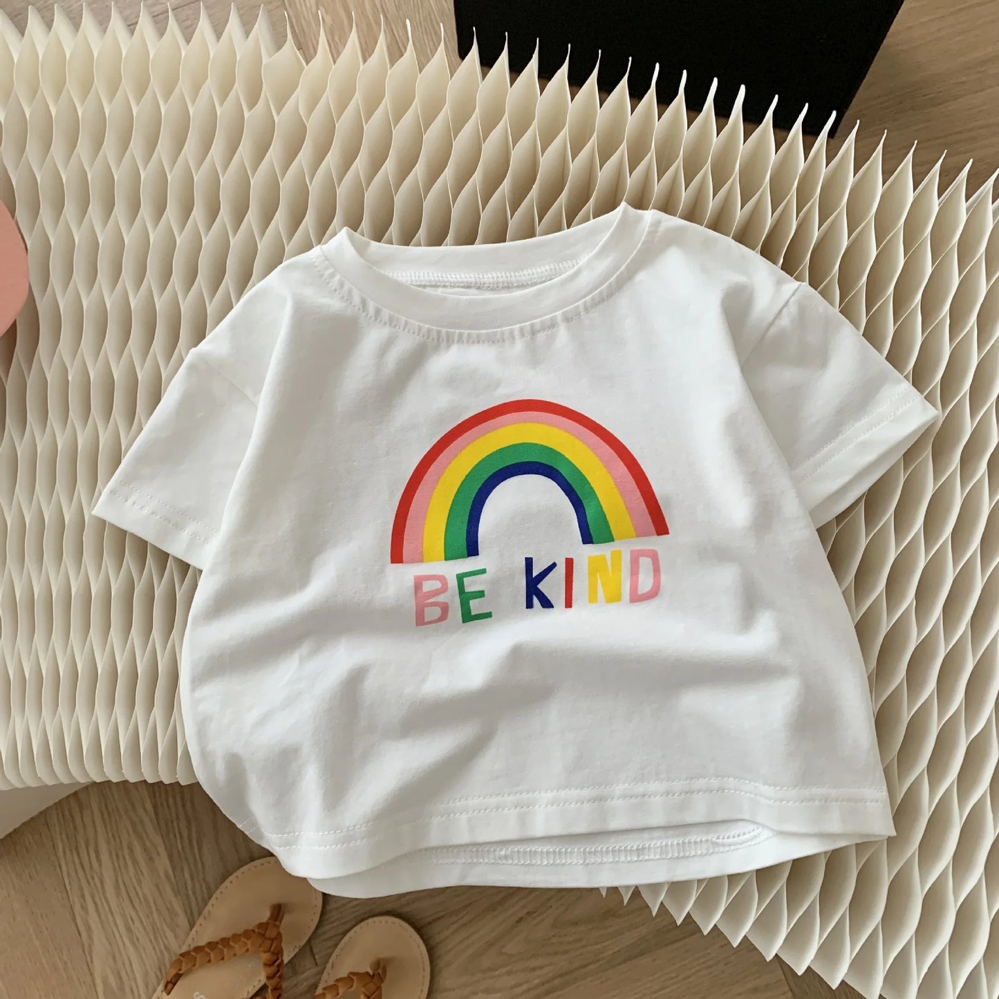 Flat lay of Be Kind Rainbow Girls Vibrant Set – soft and colorful outfit by Ju Ju Jam
