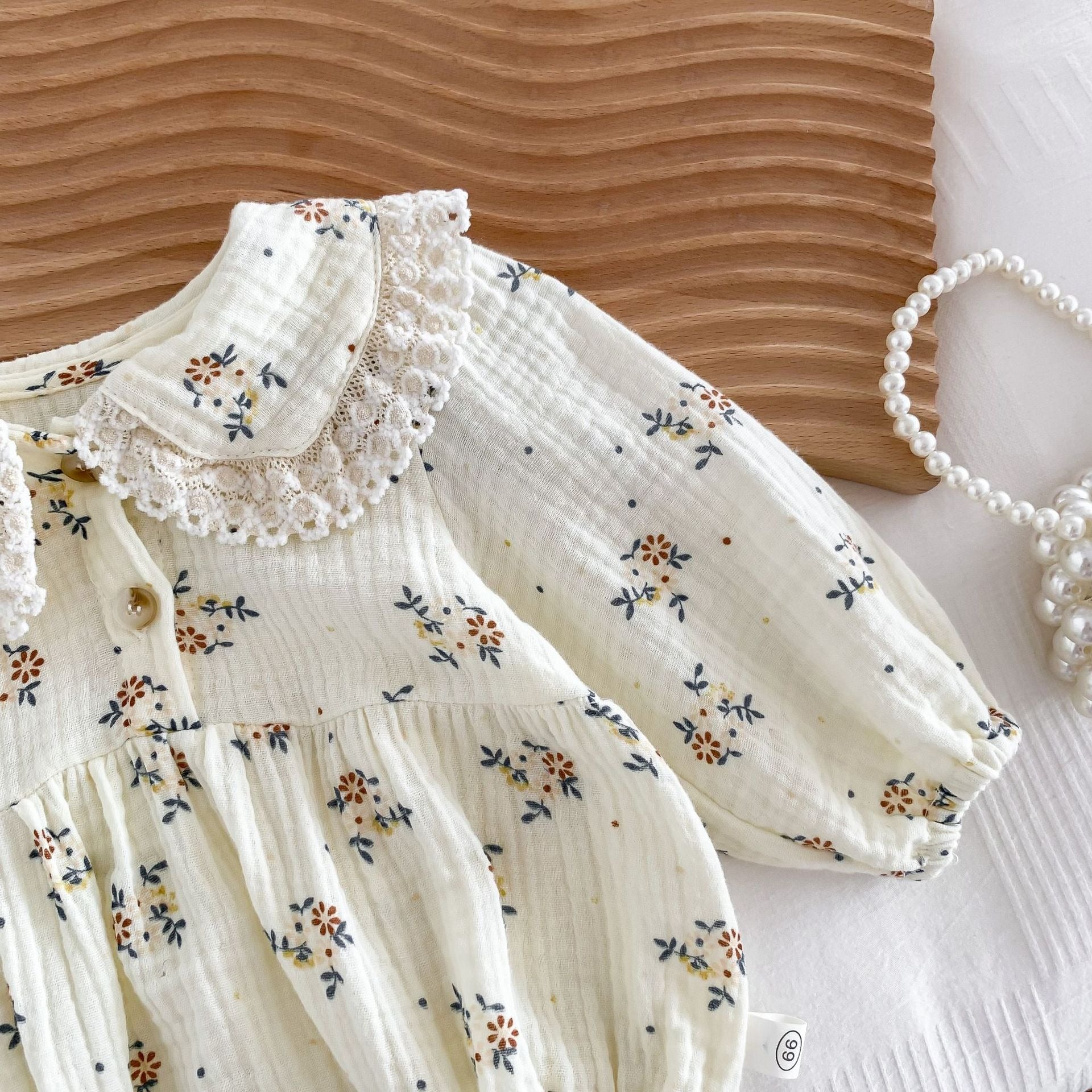 Eco-conscious baby girl romper set with cap in neutral tones – Ju Ju Jam Bella.