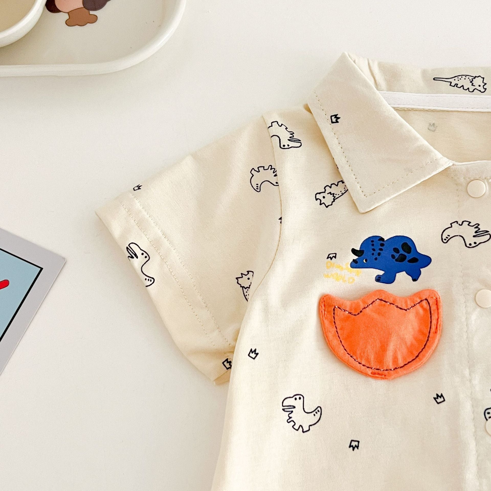 Adorable dino romper shirt β comfy and lightweight baby boys outfit from Ju Ju Jam.