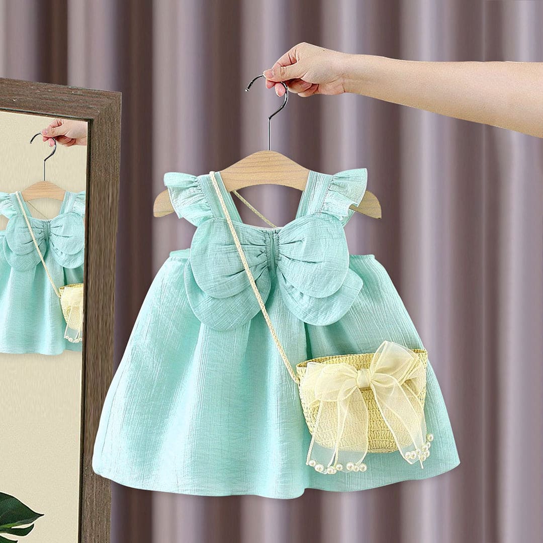 Adorable girl in Ju Ju Jam Fluttering Wings Dress with matching sling bag