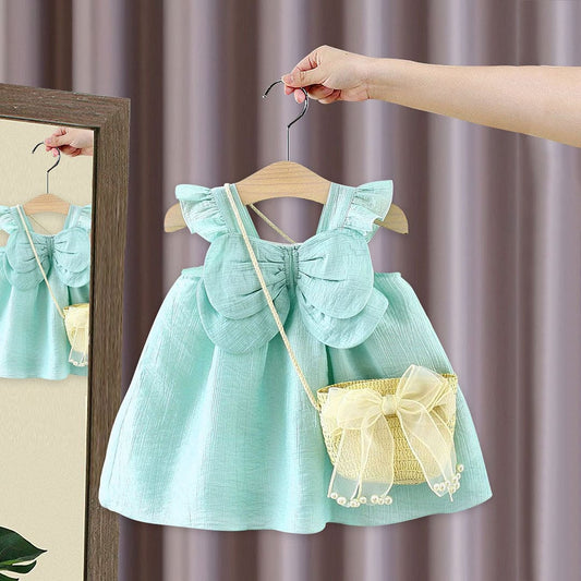 Adorable girl in Ju Ju Jam Fluttering Wings Dress with matching sling bag