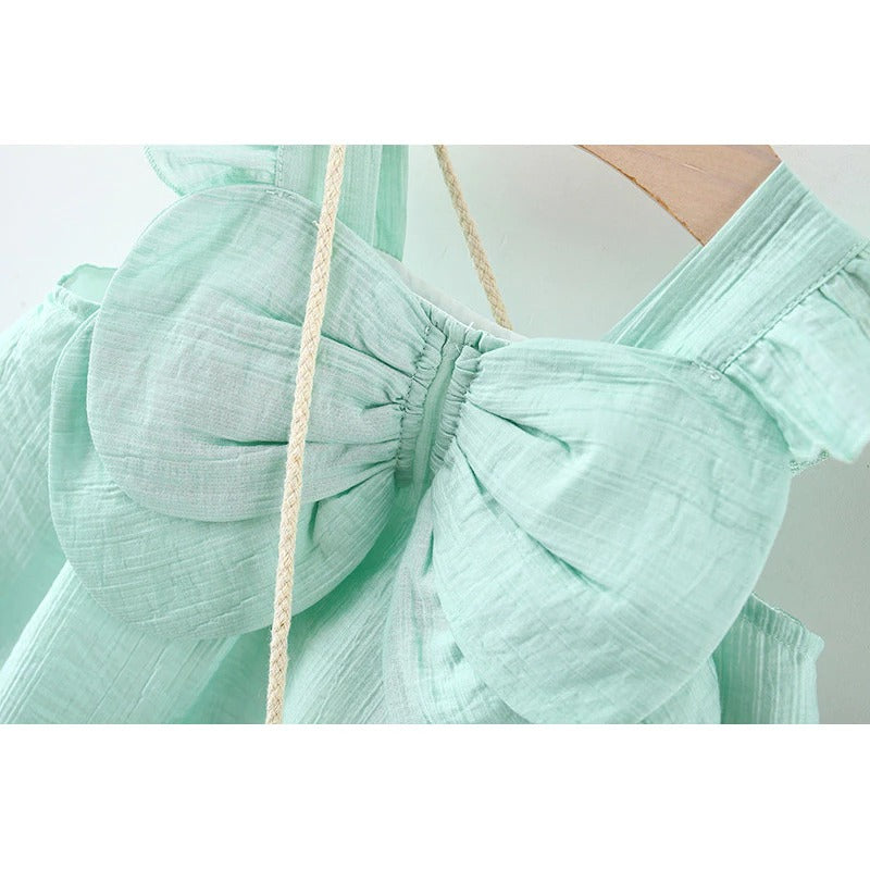 Little girl twirling in Ju Ju Jam Fluttering Wings Dress and coordinating sling bag