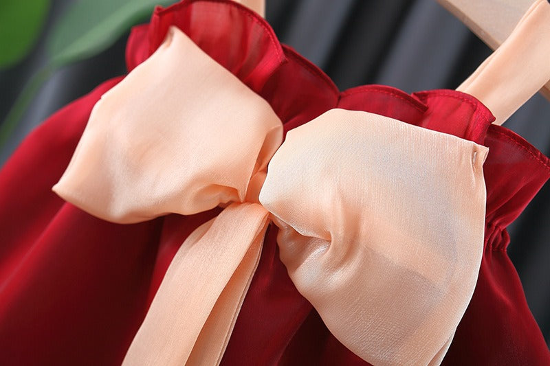 Melody Bow Girls Dress displayed on hanger – charming baby party outfit by Ju Ju Jam