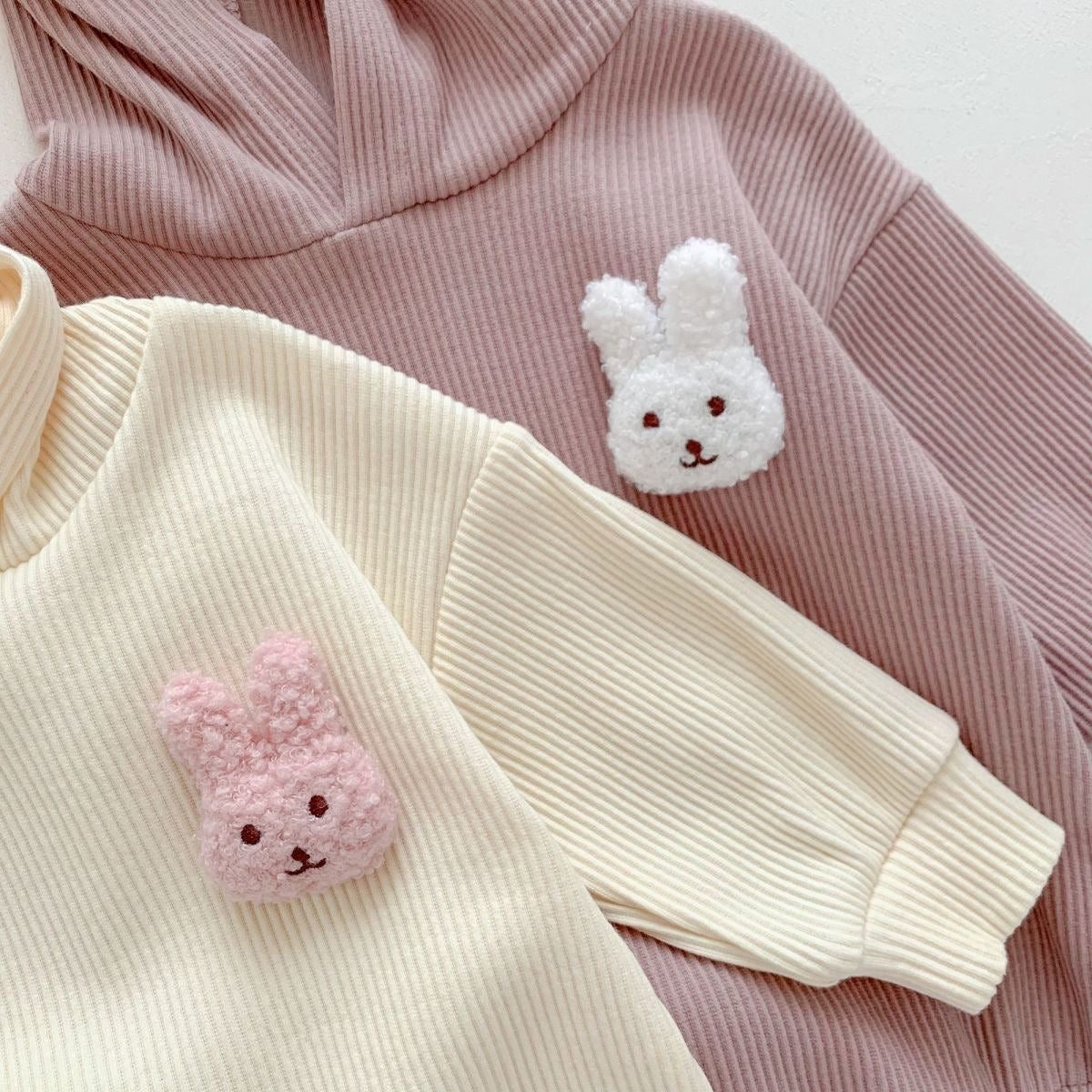 Cute rabbit-ear hooded onesie β unisex baby clothing with fluffy tail by Ju Ju Jam.
