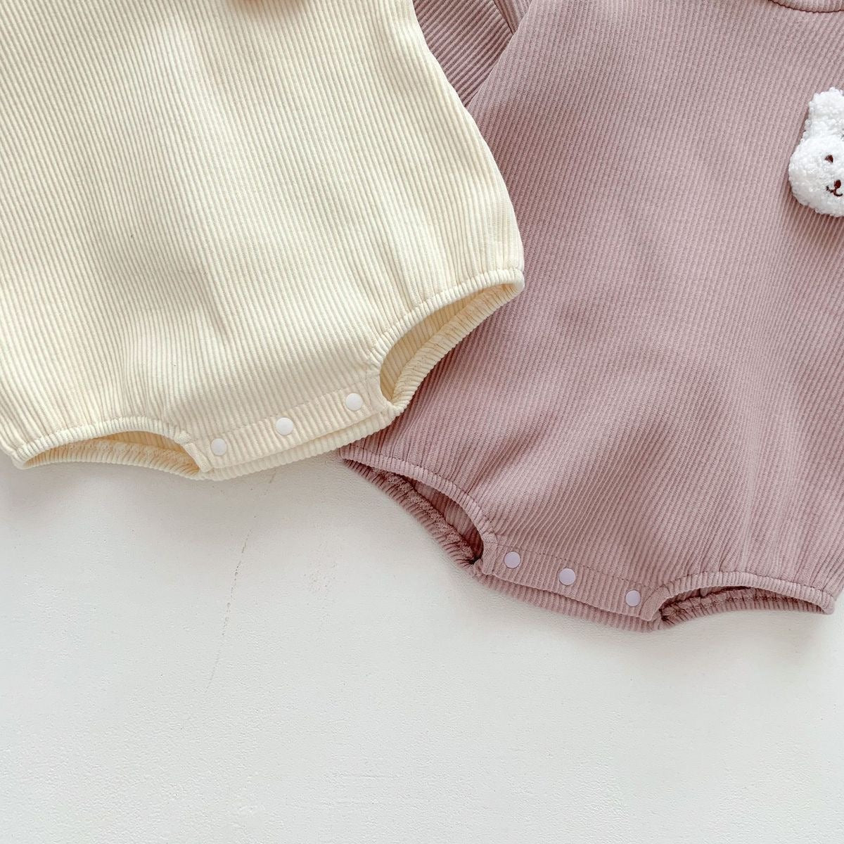 Adorable bunny onesie with rabbit tail β soft hooded outfit for baby boys and girls by Ju Ju Jam.