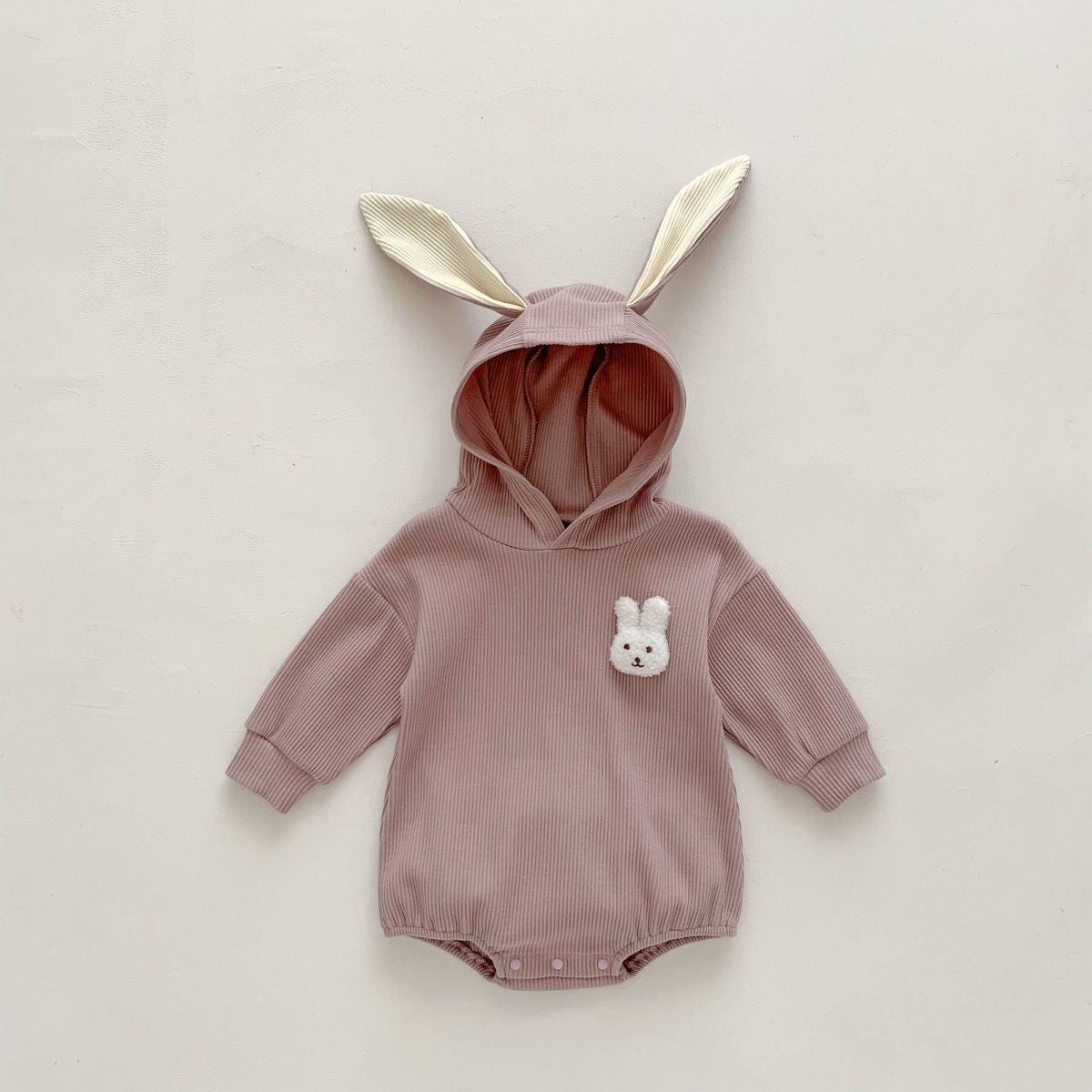 Fluffy rabbit-inspired baby onesie β soft cotton hooded romper with tail for boys and girls by Ju Ju Jam.