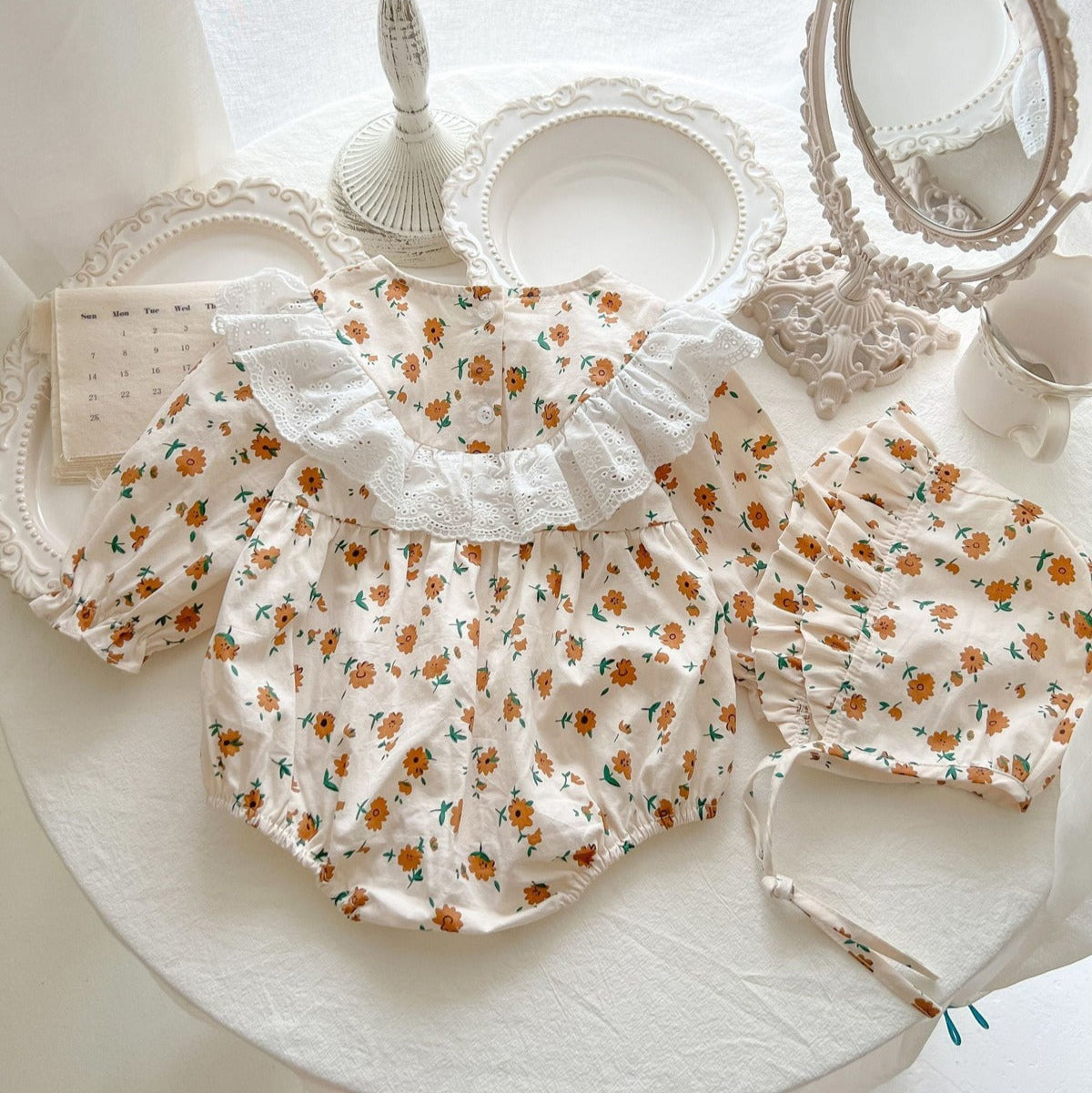 Stylish Stella baby romper with delicate frills and cute cap – girls’ outfit by Ju Ju Jam.