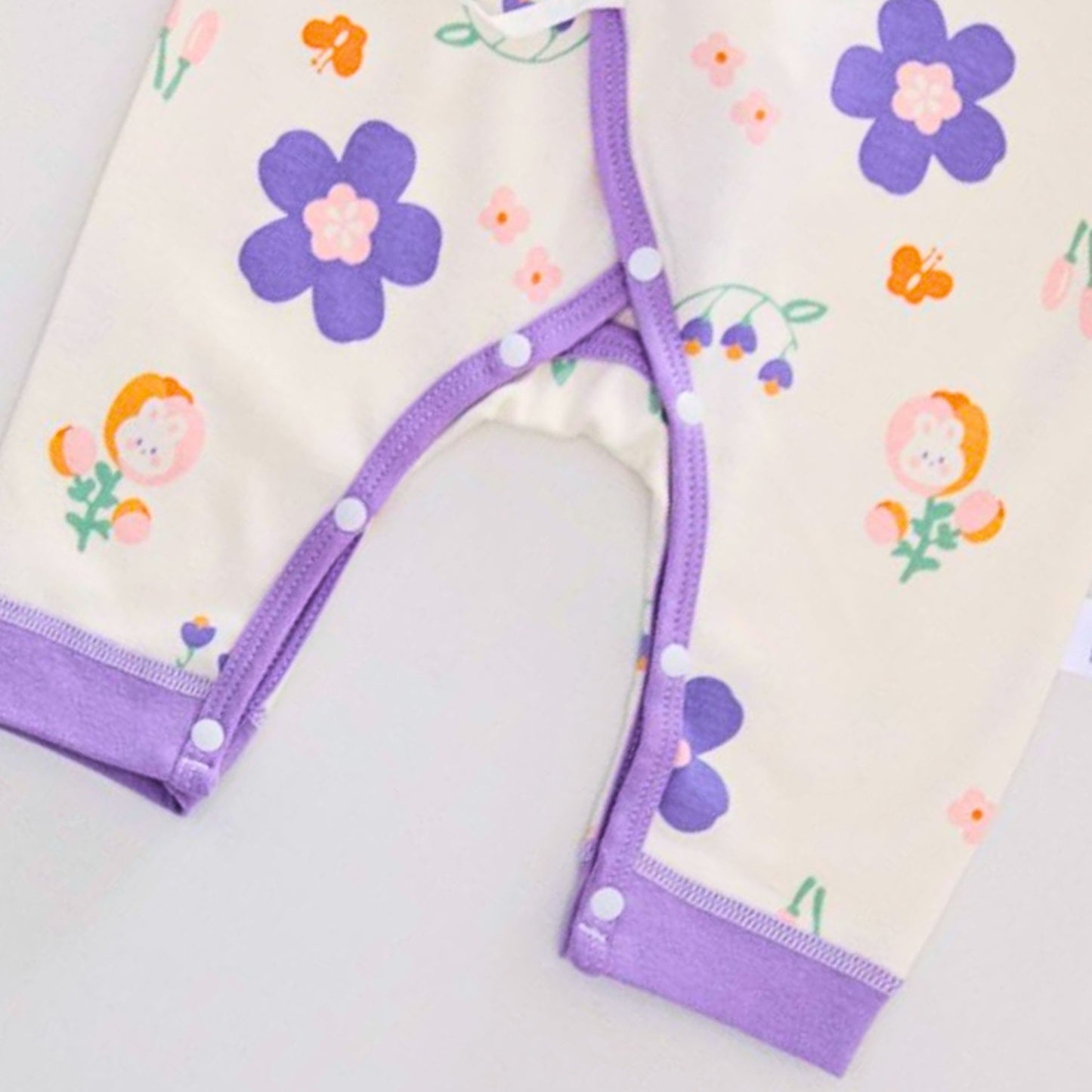 Lavender Bloom Baby Girls Romper from Ju Ju Jam, combining a soft lavender hue with a playful floral design for a cute and comfy look.