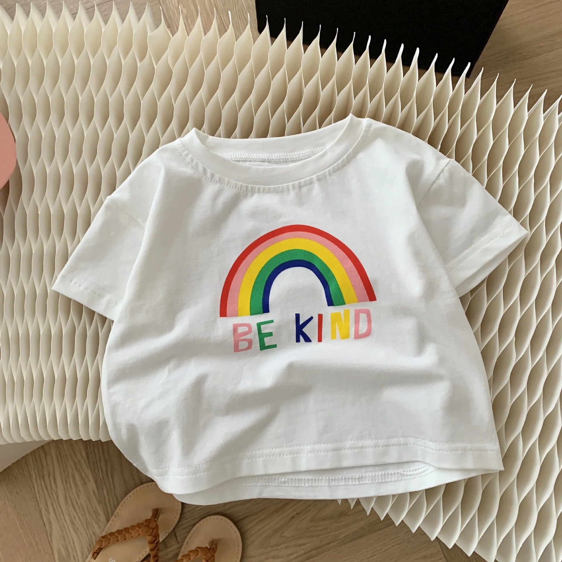 Flat lay of Be Kind Rainbow Girls Vibrant Set – soft and colorful outfit by Ju Ju Jam

