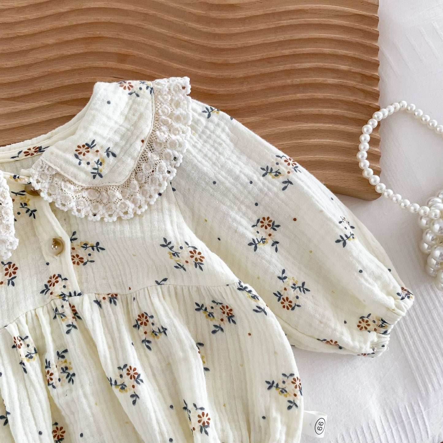 Eco-conscious baby girl romper set with cap in neutral tones – Ju Ju Jam Bella.

