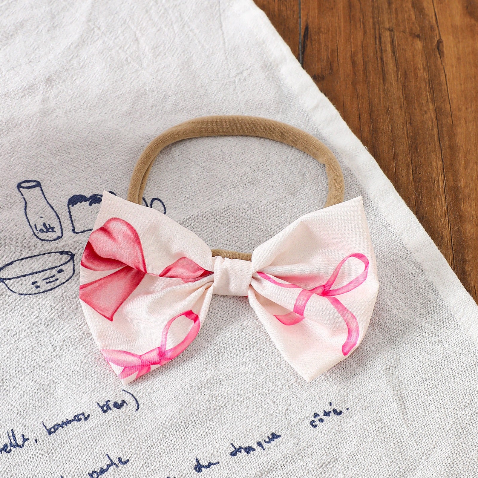 Smiling baby girl wearing Bow Belle Romper Set – perfect for parties or special days

