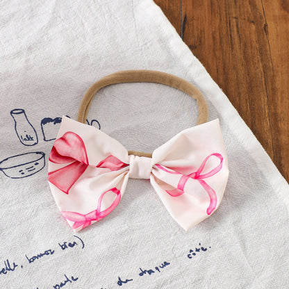 Smiling baby girl wearing Bow Belle Romper Set – perfect for parties or special days

