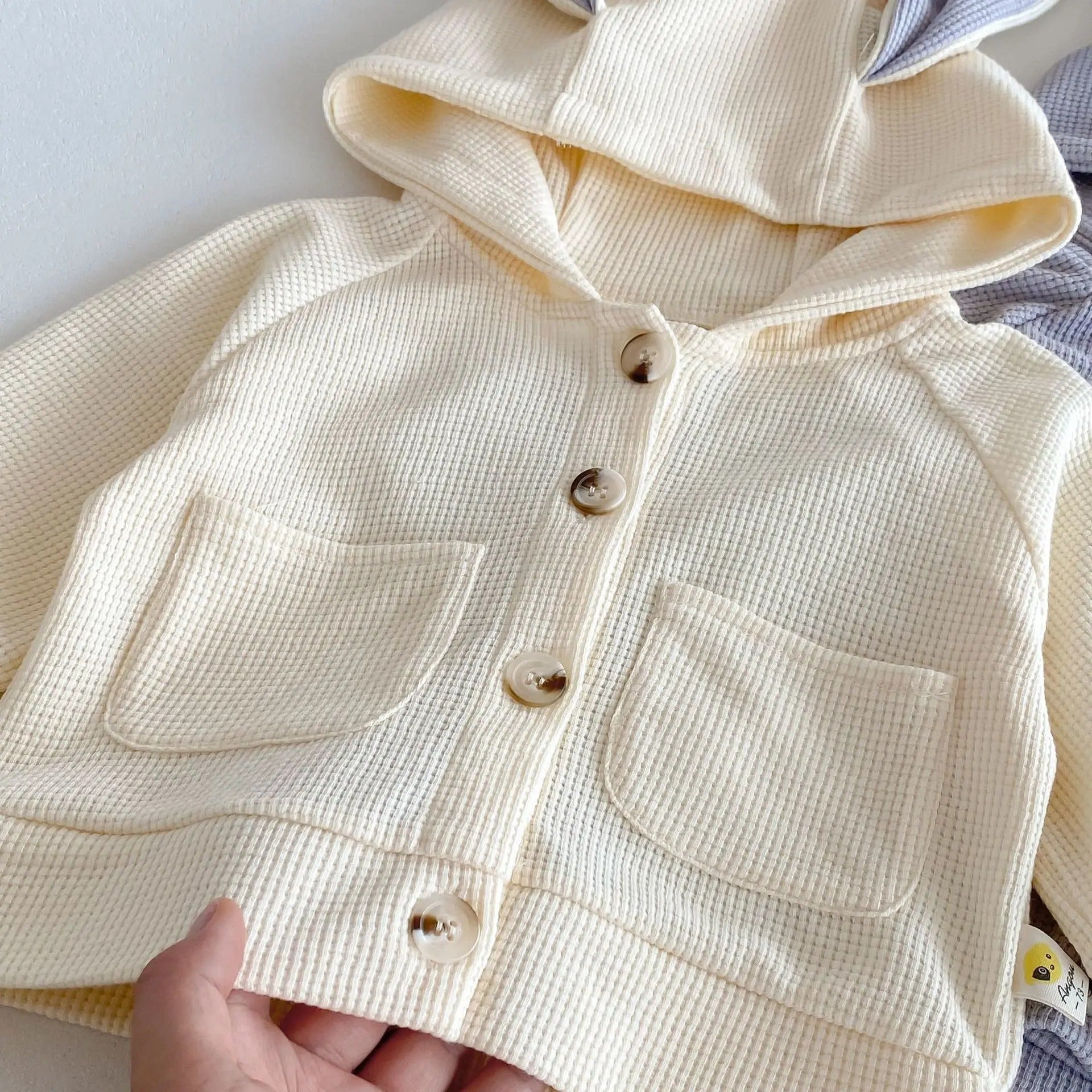 Two-piece baby co-ord set with bunny hood – unisex outfit from Ju Ju Jam perfect for playful days.


