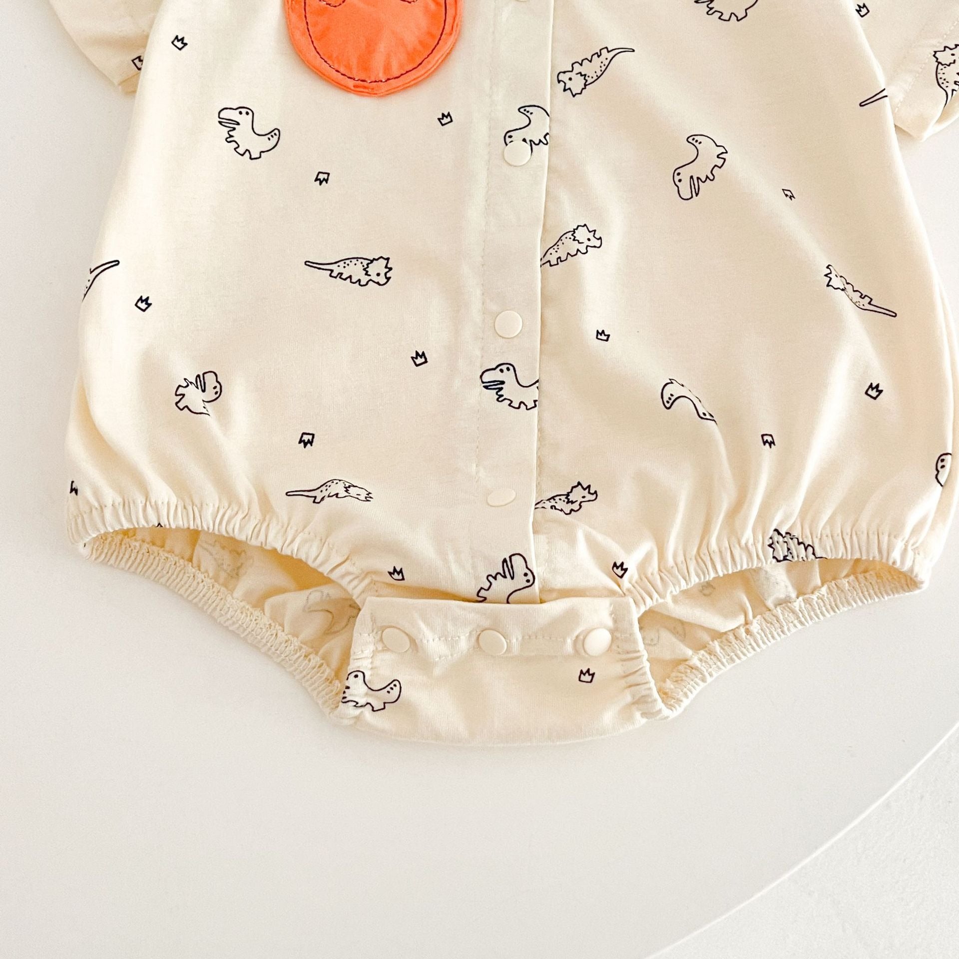 Ju Ju Jam Comfy Dino romper – dinosaur-themed baby shirt romper for boys.

