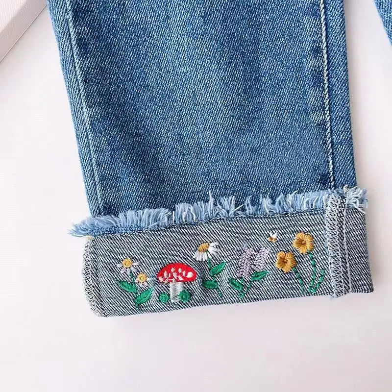 Close-up of Ju Ju Jam girls denim jeans with intricate embroidery on pant legs

