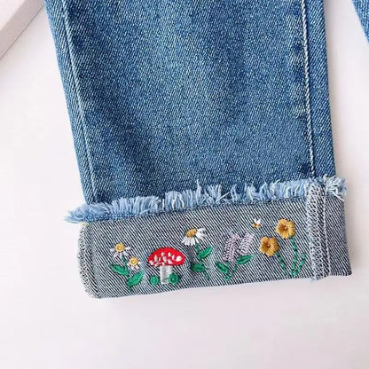 Close-up of Ju Ju Jam girls denim jeans with intricate embroidery on pant legs

