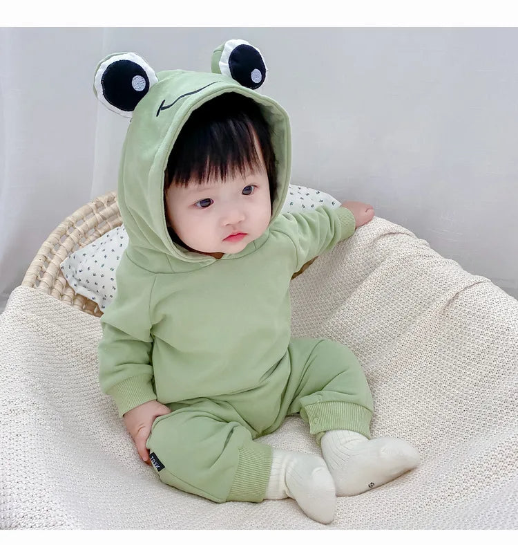 Infant dressed in a cozy Frog Eyes hooded onesie, perfect for boys and girls from Ju Ju Jam