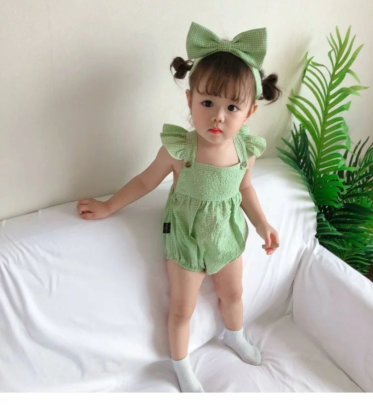 Baby girl in a Green Checkered romper with bow detail from Ju Ju Jam.