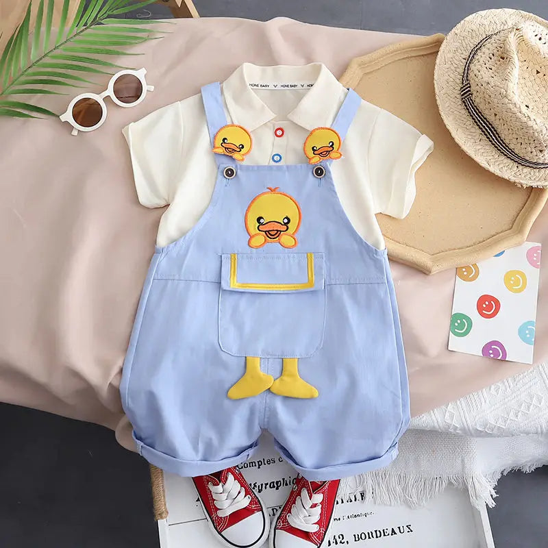 Adorable baby wearing a jumpsuit with a hanging duck design from Ju Ju Jam.