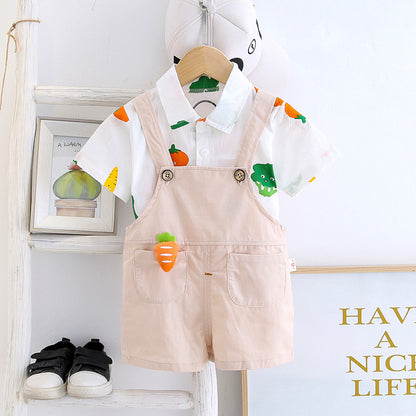 Baby boy in a Happy Veggies jumpsuit featuring cheerful vegetable prints from Ju Ju Jam."