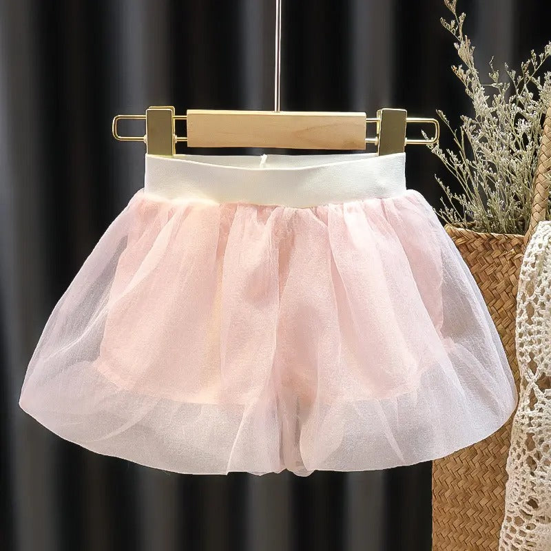 Blush Baby Girls Collared Top by Ju Ju Jam laid flat, emphasizing its soft pastel fabric and elegant structure.