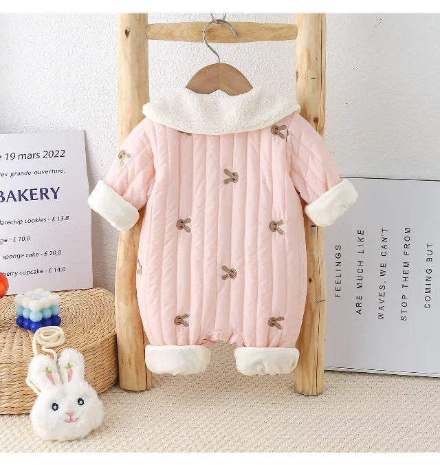 Warm and stylish pink puffer romper for baby girls, complete with a playful bunny sling, available at Ju Ju Jam.