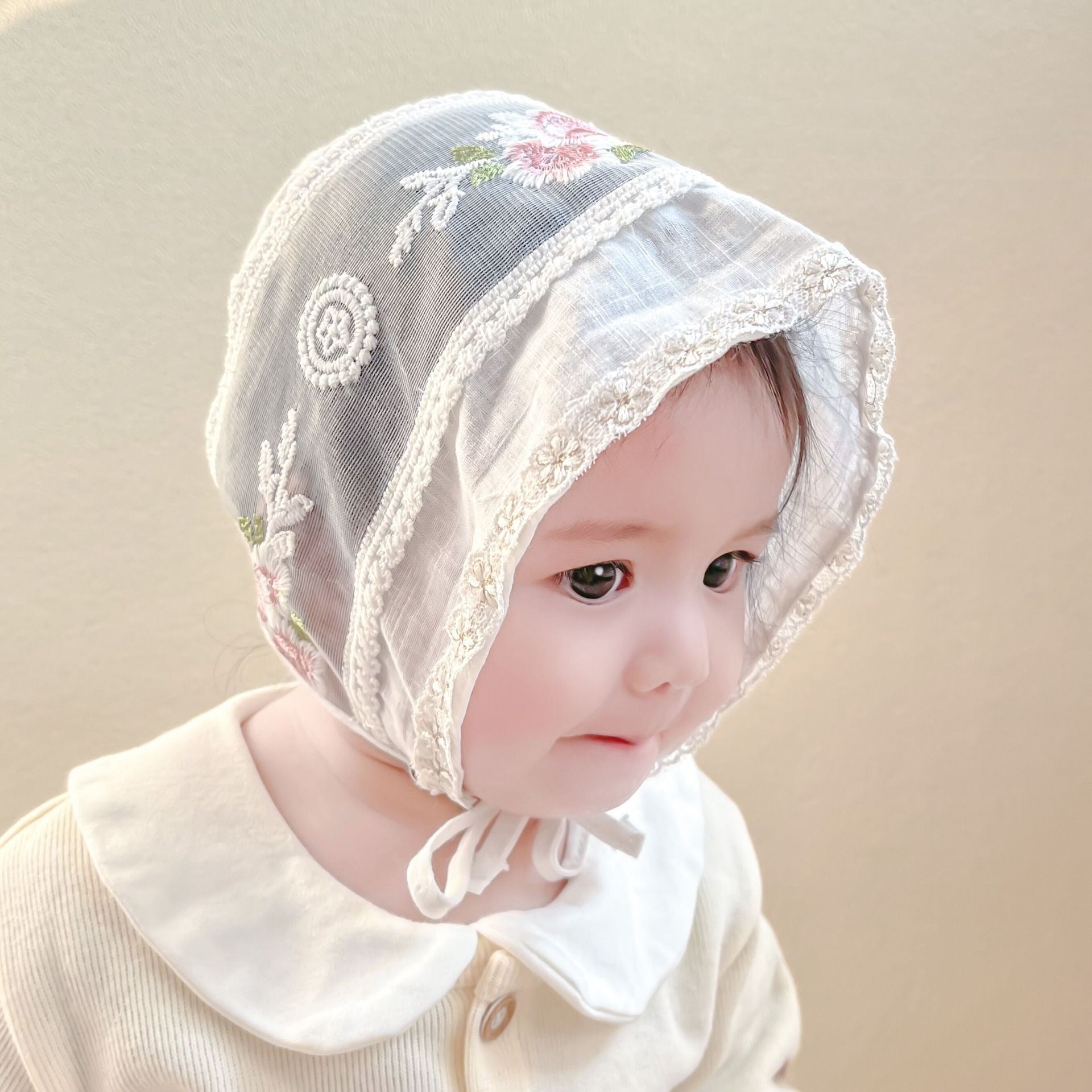 Ivory baby girl cap with embroidery – soft and stylish headwear by Ju Ju Jam.

