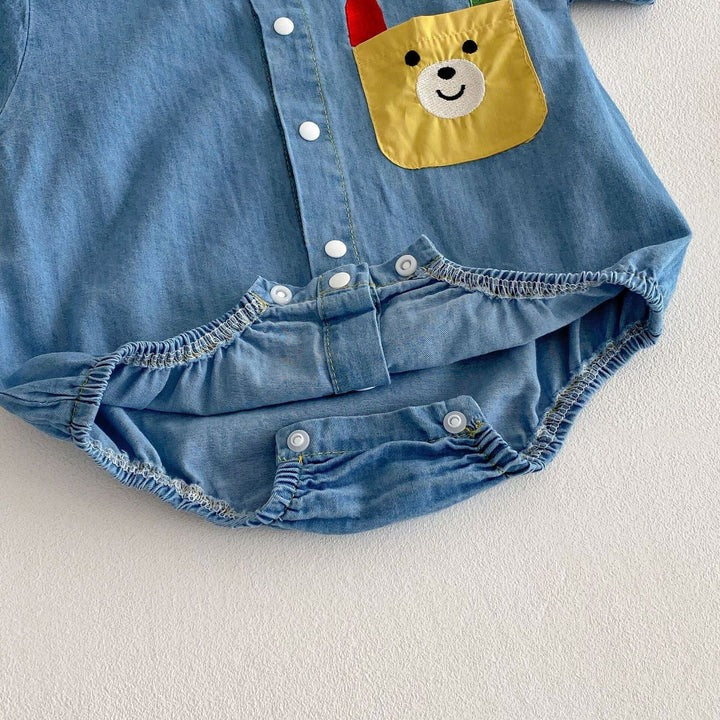 Smiling baby wearing Lil' Denim Romper – trendy and comfy outfit for little ones

