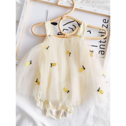 Baby girl in a Pineapple Frill romper dress from Ju Ju Jam.