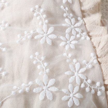 Embroidered party romper for baby girls – Pixie design by Ju Ju Jam featuring intricate detailing and a fashionable fit.

