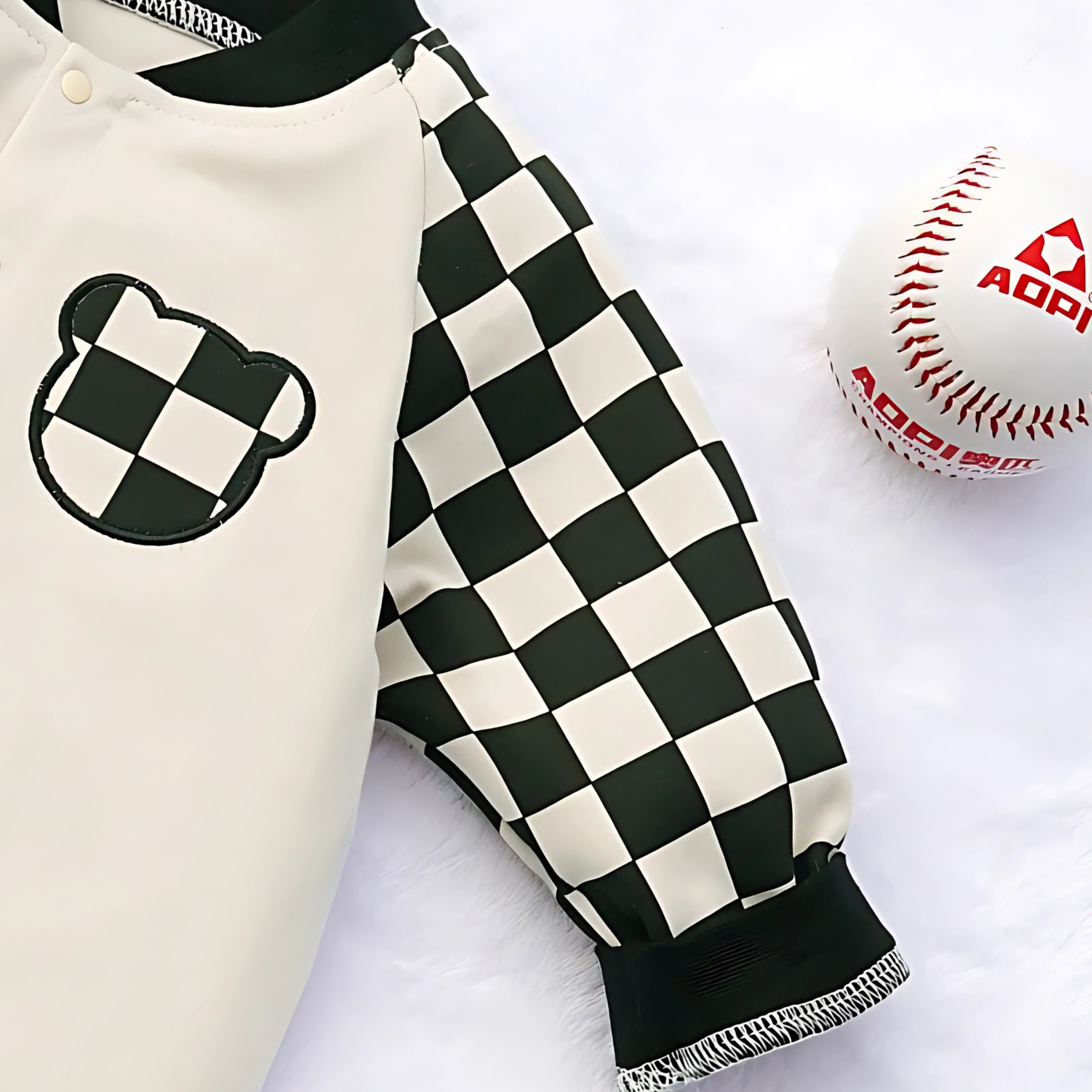 Unisex baby romper with plaid sleeves from Ju Ju Jam – cozy and trendy design

