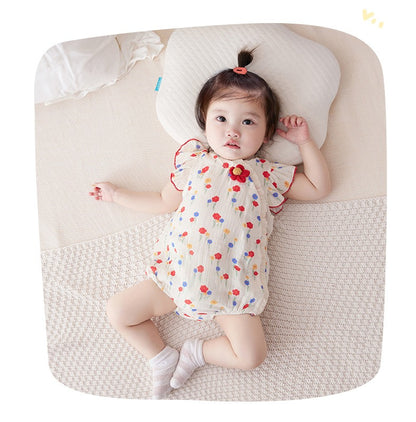 Infant wearing a Red Flower Attached romper with a vibrant flower design from Ju Ju Jam.