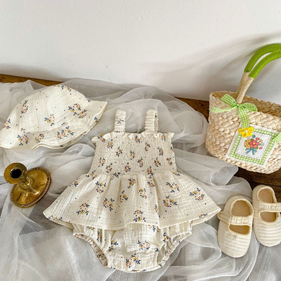 Adorable baby girl in Lily Elegant Romper Dress and matching hat – soft cotton blend outfit by Ju Ju Jam.

