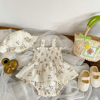 Adorable baby girl in Lily Elegant Romper Dress and matching hat – soft cotton blend outfit by Ju Ju Jam.

