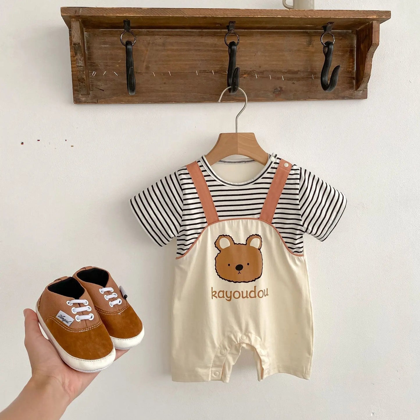 Baby boy in a Striped Bear dungaree style romper from Ju Ju Jam.