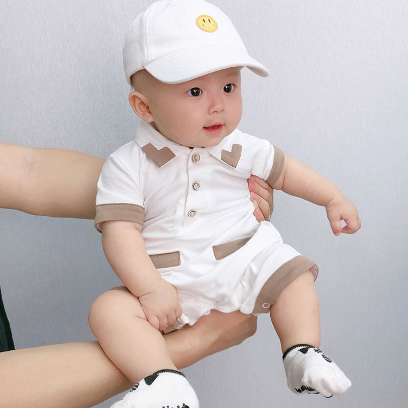 Infant dressed in a refined white collared romper, perfect for special occasions from Ju Ju Jam.